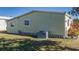 Image shows the side of the property, featuring a well-kept lawn and air conditioning unit at 8411 Regal Way, Palmetto, FL 34221