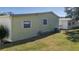 Simple home exterior with green lawn and standard air conditioning unit at 8411 Regal Way, Palmetto, FL 34221