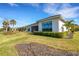 Landscaped backyard with a partially visible home and greenery at 8921 Artisan Way, Sarasota, FL 34240