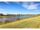 Peaceful backyard with a tranquil lake view and grassy expanse at 8921 Artisan Way, Sarasota, FL 34240