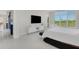 Bright bedroom with large window, TV, and access to the balcony at 8921 Artisan Way, Sarasota, FL 34240