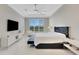 Bright and spacious primary bedroom with a large window and stylish decor at 8921 Artisan Way, Sarasota, FL 34240