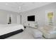 Primary bedroom with large bed, seating area, and walk-in closet at 8921 Artisan Way, Sarasota, FL 34240