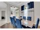 Bright dining area with dark hardwood floors and blue accents at 8921 Artisan Way, Sarasota, FL 34240
