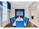 Formal dining room with blue velvet chairs and modern chandelier at 8921 Artisan Way, Sarasota, FL 34240