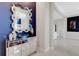Modern entryway with a mirrored console table and blue accent wall at 8921 Artisan Way, Sarasota, FL 34240