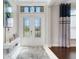 Bright and airy foyer with double doors and modern console table at 8921 Artisan Way, Sarasota, FL 34240