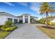 White two-story house with gray roof, double door entry, and two-car garage at 8921 Artisan Way, Sarasota, FL 34240