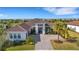 Luxury home with tile roof, palm trees, and a paved driveway at 8921 Artisan Way, Sarasota, FL 34240