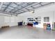 Spacious garage with high ceiling, shelving, and ample storage at 8921 Artisan Way, Sarasota, FL 34240