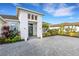 Stunning curb appeal with a gray double door entry and manicured landscaping at 8921 Artisan Way, Sarasota, FL 34240