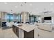 Modern kitchen island with seating, stainless steel appliances, and open layout at 8921 Artisan Way, Sarasota, FL 34240