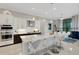 Modern kitchen with white and dark cabinets, large island, and stainless steel appliances at 8921 Artisan Way, Sarasota, FL 34240