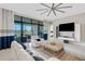 Living room with white sofas, large windows and a view of the lake at 8921 Artisan Way, Sarasota, FL 34240