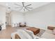 Open living space with sectional sofa, ottoman, and ceiling fan at 8921 Artisan Way, Sarasota, FL 34240