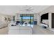 Living area features white sofas, large windows, and access to patio at 8921 Artisan Way, Sarasota, FL 34240