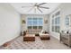 Bright living room featuring a sectional sofa, large windows, and a ceiling fan at 8921 Artisan Way, Sarasota, FL 34240