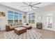 Spacious living area with sectional sofa, a ceiling fan and access to outdoor patio at 8921 Artisan Way, Sarasota, FL 34240