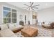 Spacious living area with sectional sofa, a ceiling fan and access to outdoor patio at 8921 Artisan Way, Sarasota, FL 34240