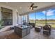 Covered patio with outdoor kitchen, seating area, and water view at 8921 Artisan Way, Sarasota, FL 34240