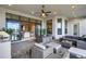 Covered patio with outdoor kitchen, seating area, and water view at 8921 Artisan Way, Sarasota, FL 34240