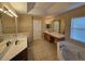 Primary bathroom featuring dual sinks, a jetted tub, and a separate shower at 779 Nectar Rd, Venice, FL 34293