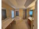 Main bathroom with double vanities, corner jetted tub, separate shower, and tiled floors at 779 Nectar Rd, Venice, FL 34293