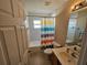 Bathroom with shower-tub, vanity, and striped shower curtain at 779 Nectar Rd, Venice, FL 34293