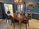 Elegant dining room with a large wooden table, leather chairs, and a stylish chandelier at 779 Nectar Rd, Venice, FL 34293