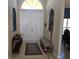 Inviting entryway with double doors, a bench, and decorative rug at 779 Nectar Rd, Venice, FL 34293