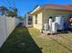Side view of the house with a white fence and pool enclosure at 779 Nectar Rd, Venice, FL 34293