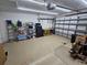 Two-car garage with storage shelves, workbench, and garage door opener at 779 Nectar Rd, Venice, FL 34293