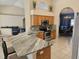 View of the kitchen with granite countertops, stainless steel appliances, and an adjacent dining area at 779 Nectar Rd, Venice, FL 34293