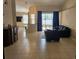 Open-concept living area with tile floors, neutral walls, and sliding glass doors leading to the pool at 779 Nectar Rd, Venice, FL 34293