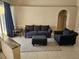 Living room with plush seating, an ottoman, and tiled flooring at 779 Nectar Rd, Venice, FL 34293