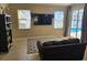 Gathering room with tile flooring, large TV, and sliding doors to the pool area at 779 Nectar Rd, Venice, FL 34293