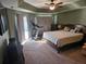 Spacious main bedroom with a king-size bed, ceiling fan, and private balcony access at 779 Nectar Rd, Venice, FL 34293