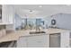Open concept kitchen boasting stainless steel appliances and a breakfast bar at 101 S Gulfstream Ave # 15E, Sarasota, FL 34236