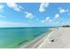 Relaxing beach scene with calm water and blue sky at 108 Corte Del Rosa, Venice, FL 34285