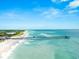 Long pier over ocean; beach with people visible at 108 Corte Del Rosa, Venice, FL 34285