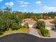 Single-Gathering home with tile roof, driveway, and landscaped yard in a residential neighborhood at 108 Corte Del Rosa, Venice, FL 34285