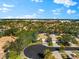 Single-Gathering house with a tile roof nestled in a community of similar homes at 108 Corte Del Rosa, Venice, FL 34285