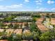 Aerial view of single-Gathering home with surrounding houses and landscape at 108 Corte Del Rosa, Venice, FL 34285