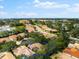 Aerial view of single-Gathering home with solar panels and lush landscape at 108 Corte Del Rosa, Venice, FL 34285