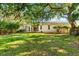 Large backyard, partially shaded, with a screened enclosure at 108 Corte Del Rosa, Venice, FL 34285