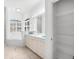 Clean bathroom with double sinks, tub, and linen closet at 108 Corte Del Rosa, Venice, FL 34285