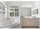 Spa-like bathroom with corner tub and double vanity at 108 Corte Del Rosa, Venice, FL 34285