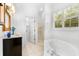 Bathroom with soaking tub, walk-in shower and vanity at 108 Corte Del Rosa, Venice, FL 34285
