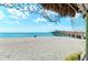 Peaceful beach view with pier in the distance at 108 Corte Del Rosa, Venice, FL 34285