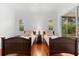 Bedroom with two twin beds, nightstand and access to a screened porch at 108 Corte Del Rosa, Venice, FL 34285